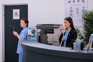 Clinic reception staff assisting patients while efficient medical billing and revenue cycle management support clinic growth.