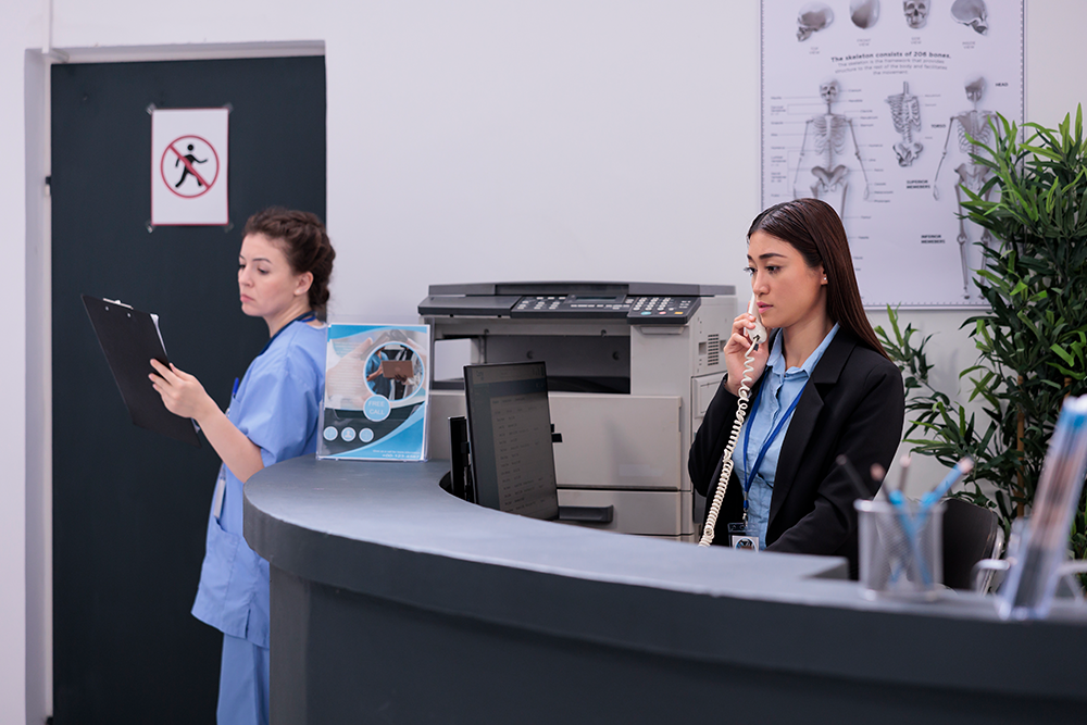 Clinic reception staff assisting patients while efficient medical billing and revenue cycle management support clinic growth.